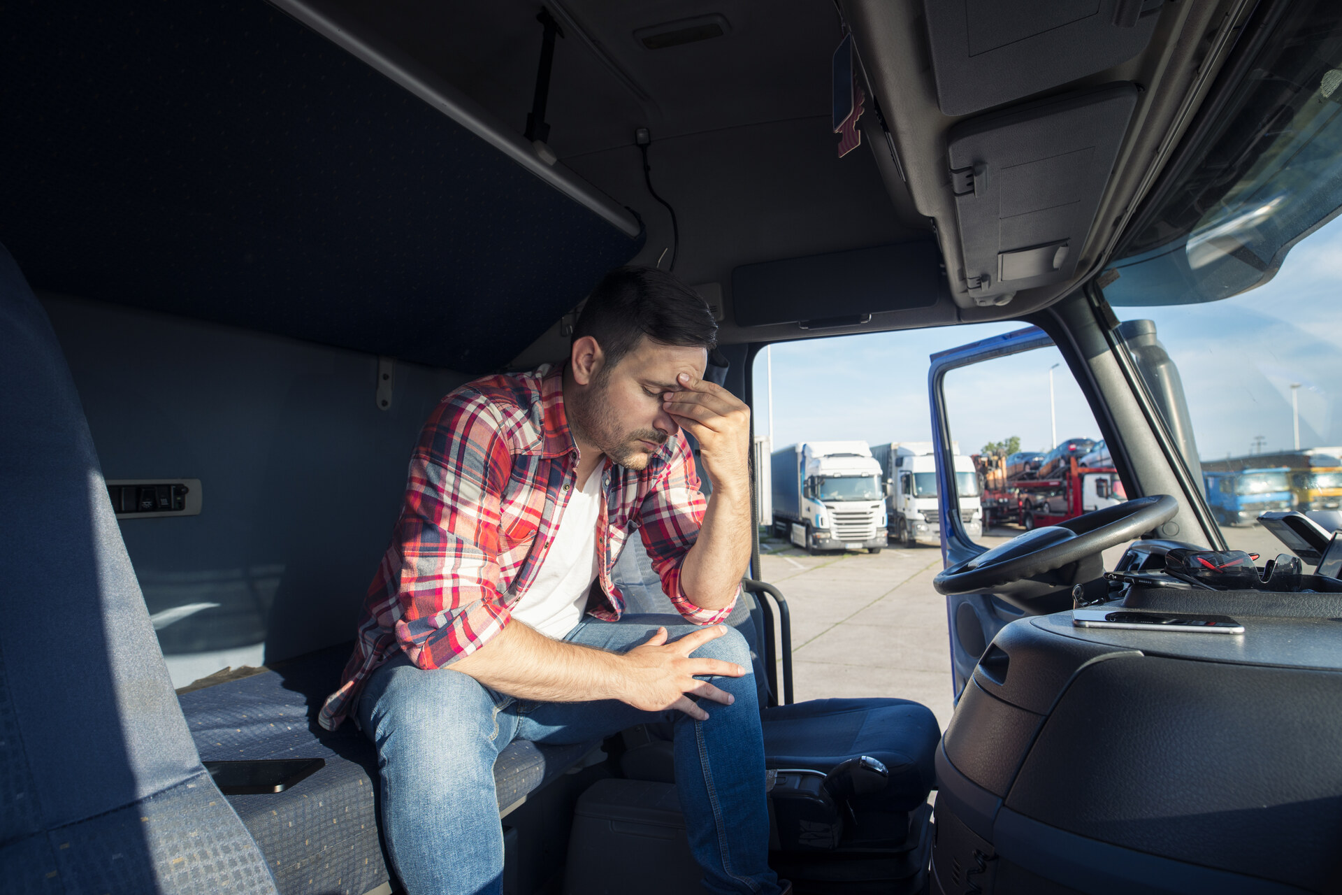 Worried truck driver sitting in cabin Worried truck driver sitting in cabin