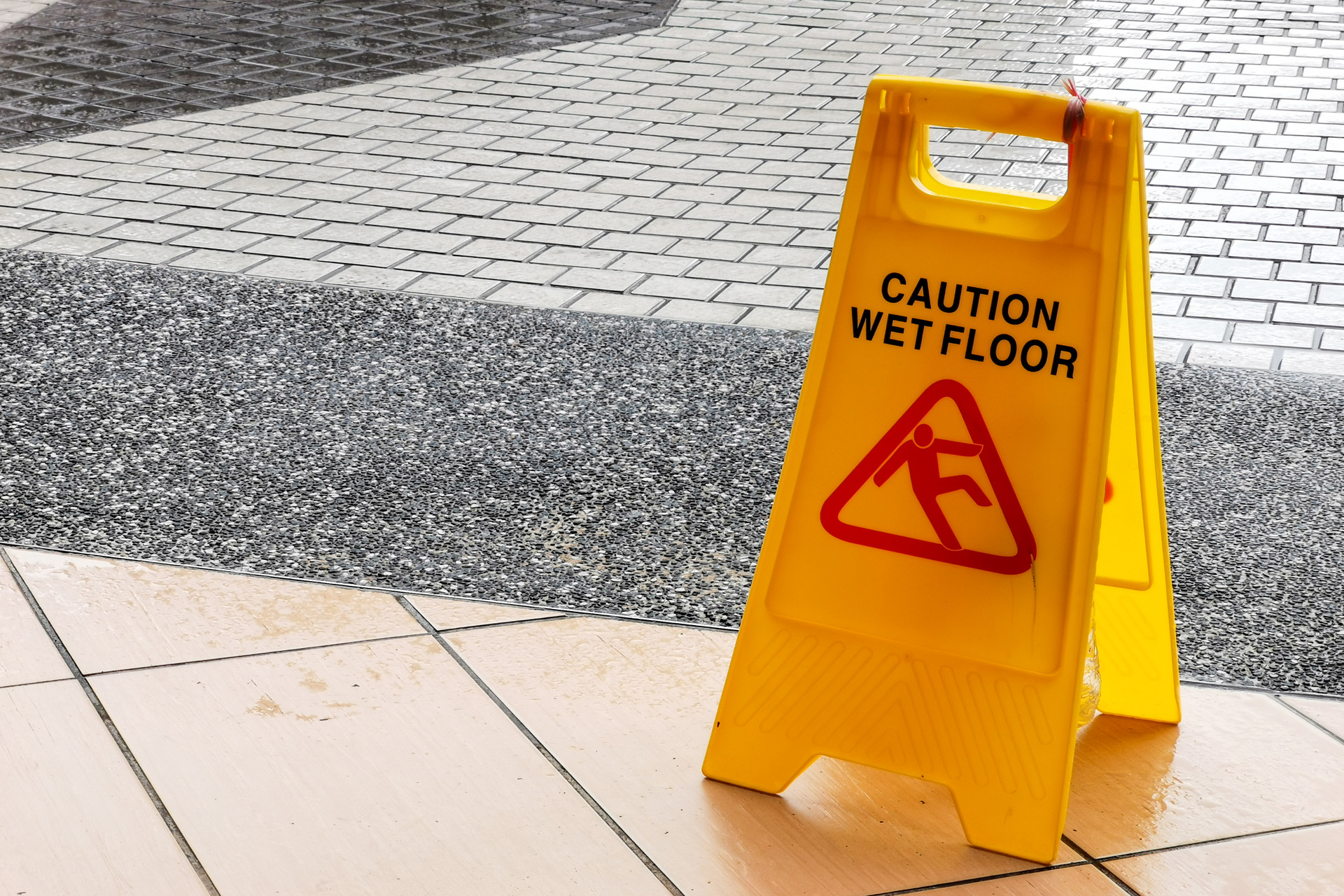 Wet floor caution sign at the building entrance Wet floor caution sign at the building entrance