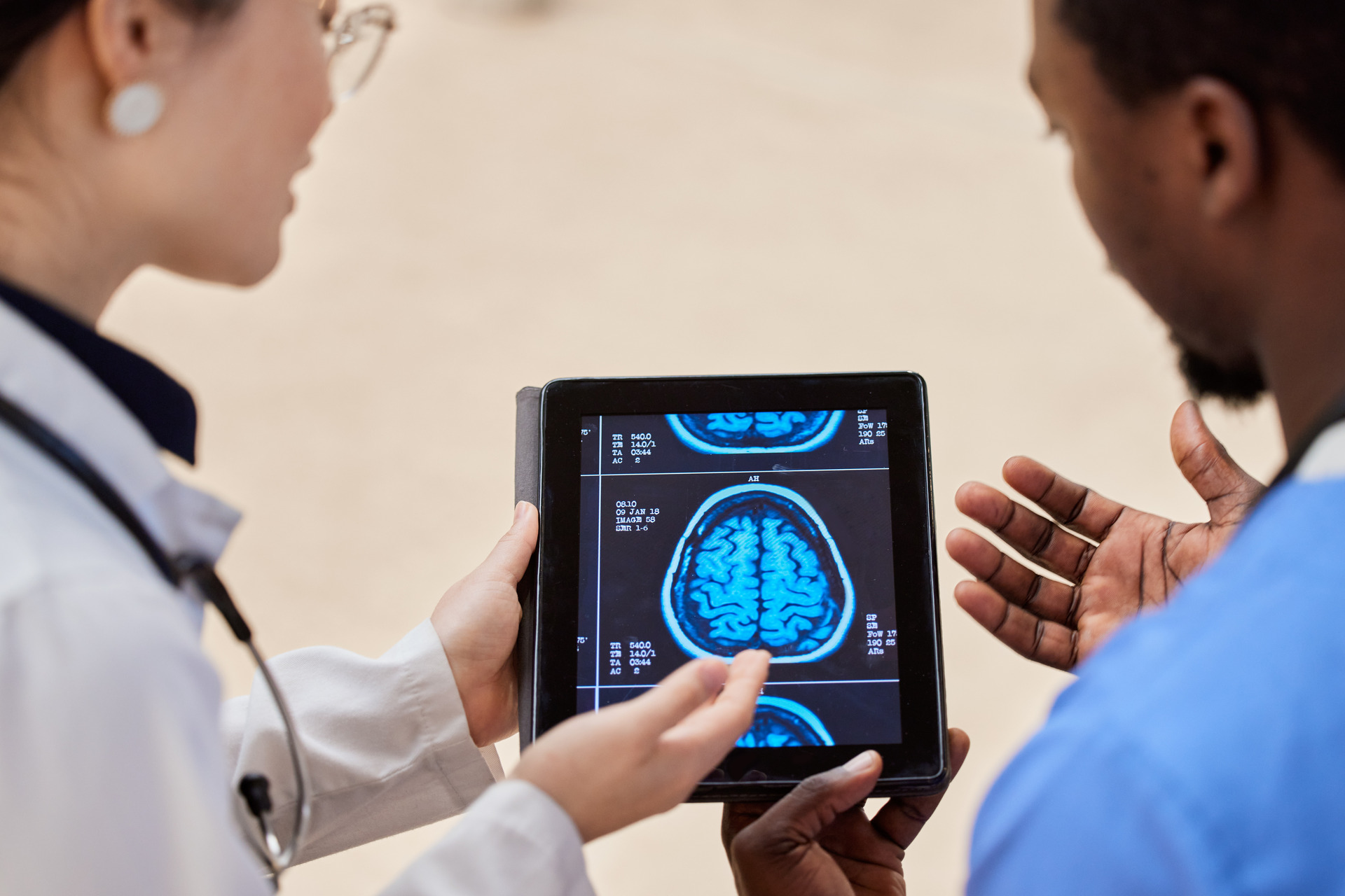 x-ray-of-the-brain-with-a-doctor-and-patient puppy playfully engaging with owner