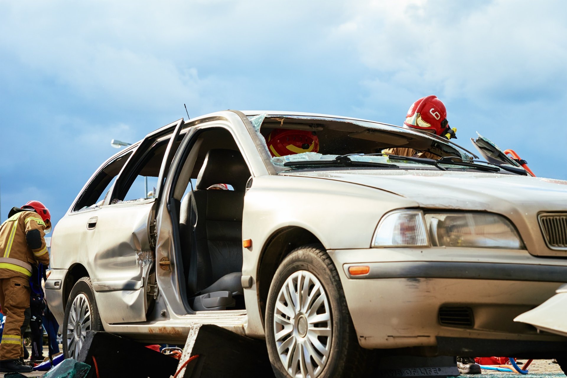 Firefighters conducting vehicle rescue operation at car accident site
