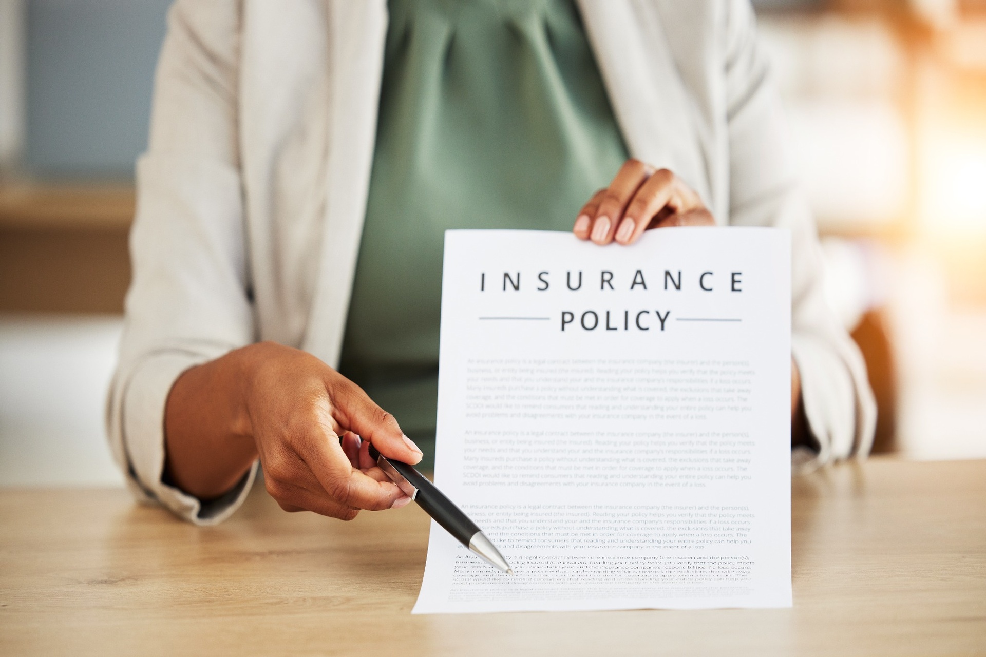 Person showing insurance policy and pointing with pen Person showing insurance policy and pointing with pen