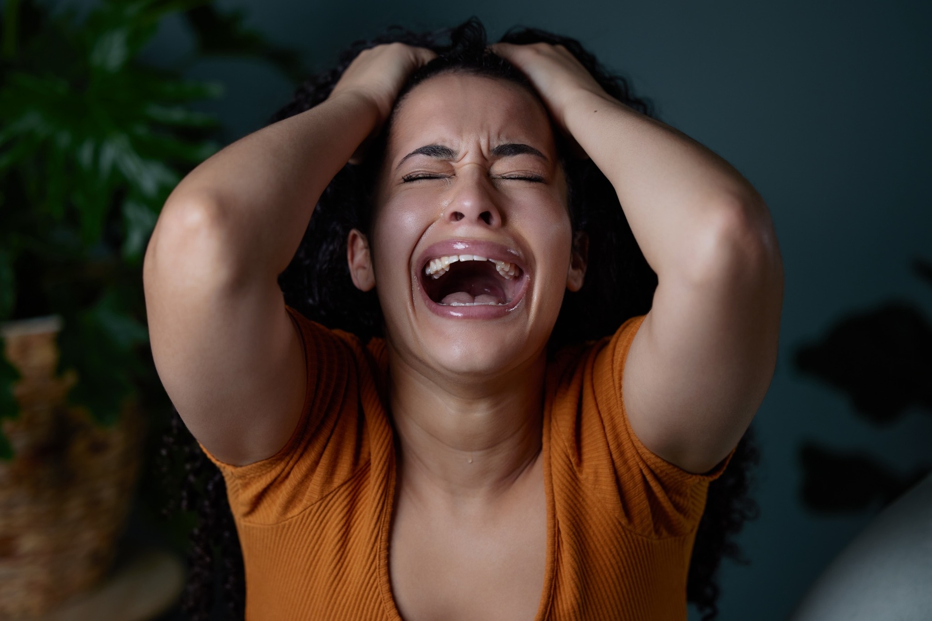 Upset woman crying with hands on head Upset woman crying with hands on head