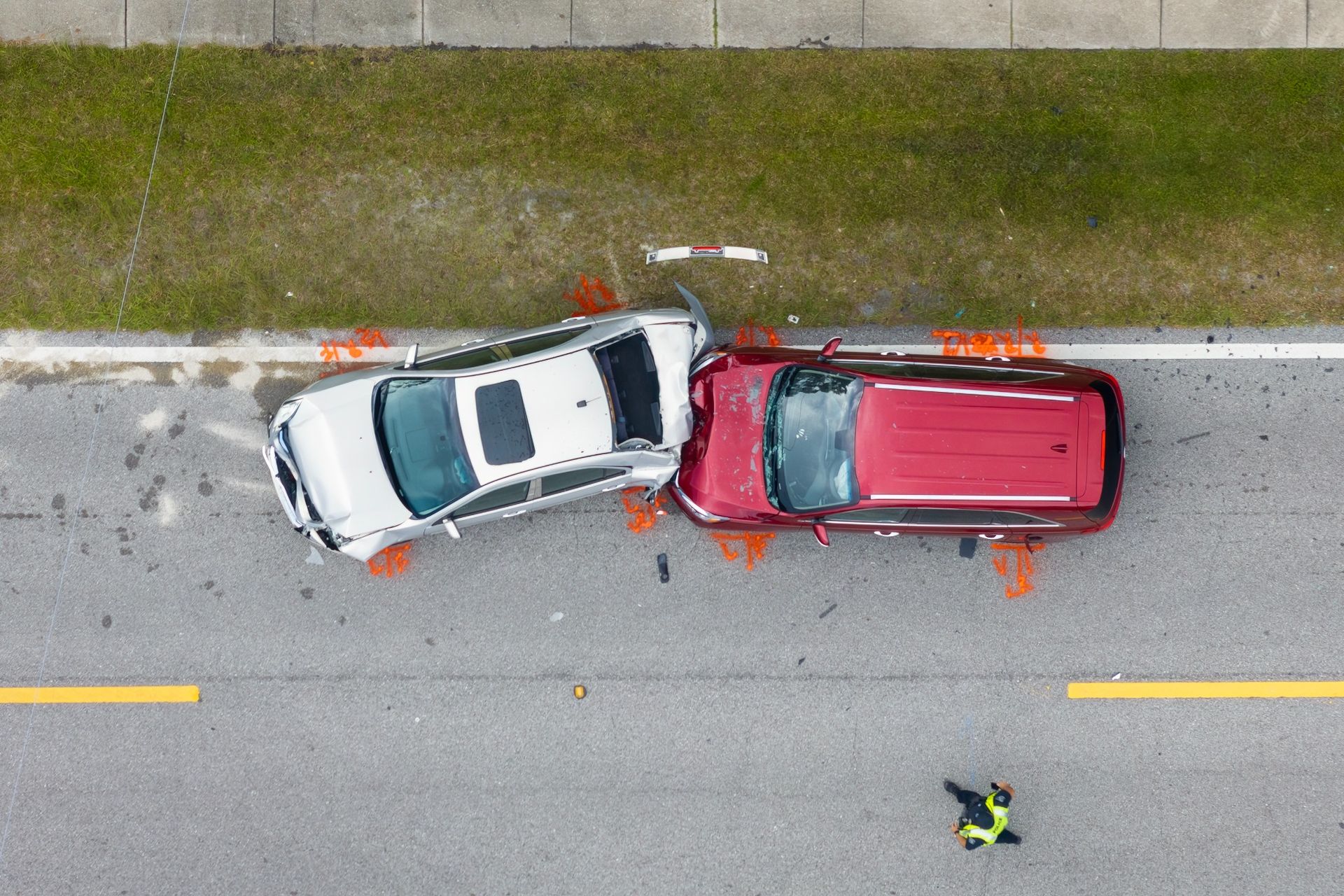 Aerial view of two vehicles involved in a head-on collision with marked accident scene Aerial view of two vehicles involved in a head-on collision with marked accident scene