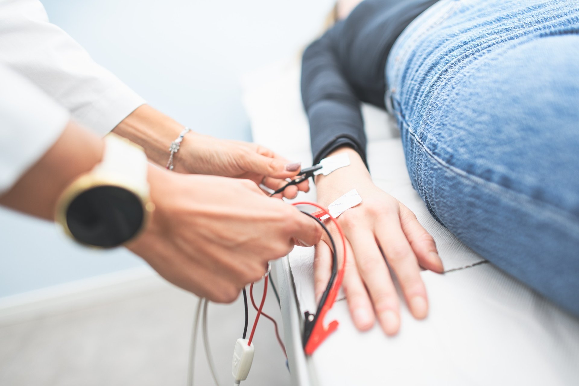 Close-up of medical device attached to a woman's hand during an examination Close-up of medical device attached to a woman's hand during an examination