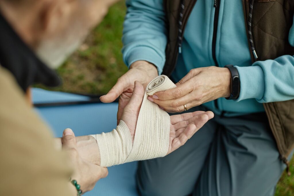 Person Wrapping Bondage Over Injured Hand